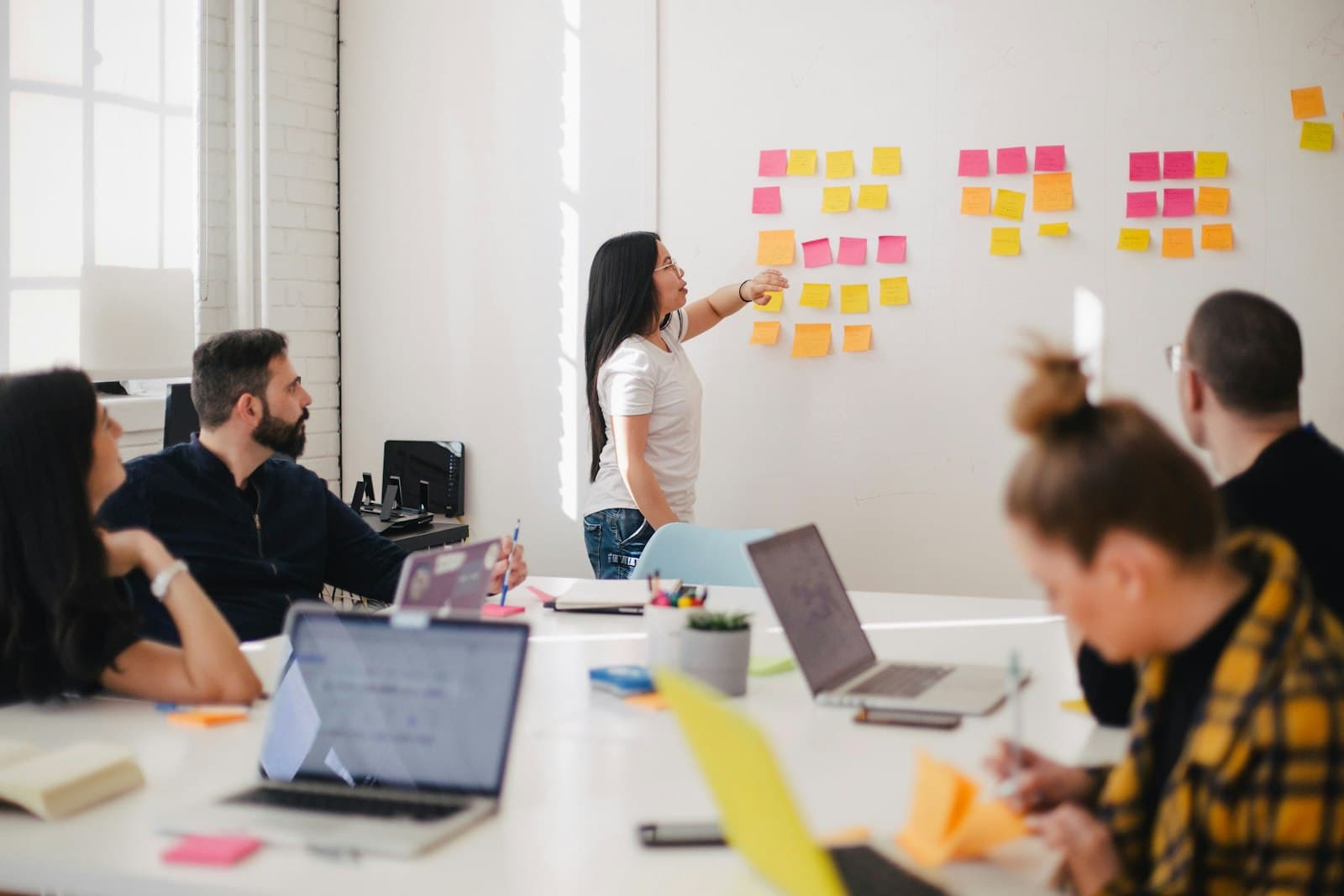 Startup founders collaborating around a laptop during a product planning session
